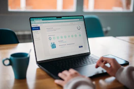 Person using a laptop to review a rewards program.