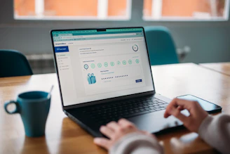 Person using a laptop to review a rewards program.