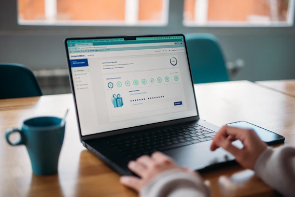 Person using a laptop to review a rewards program.