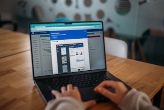 Someone is working on a laptop, viewing a presentation.