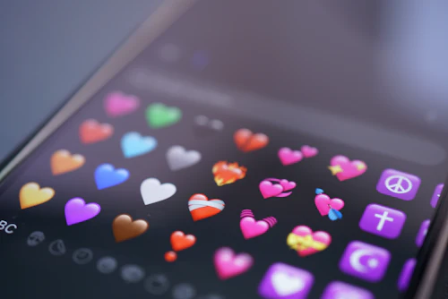 A smartphone screen filled with colorful heart emojis