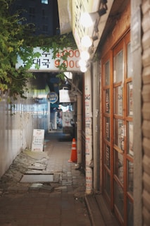 An alleyway at night with a restaurant.