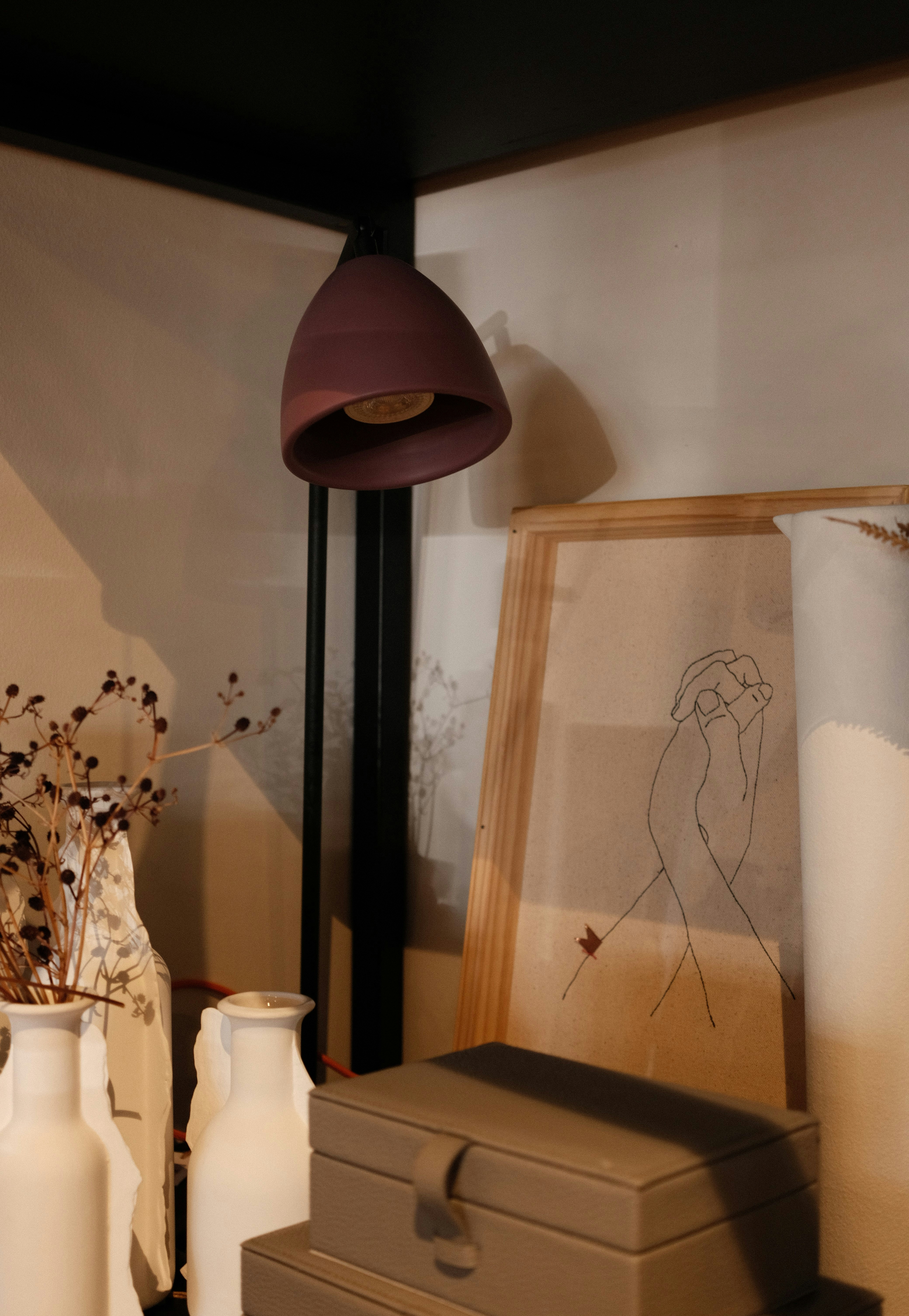 A lamp illuminates an artistic display.