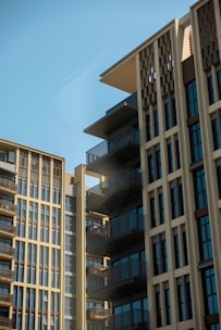 Modern buildings stand tall against a bright blue sky.