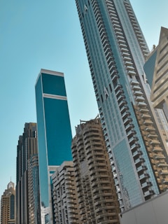 Skyscrapers reaching towards a clear blue sky.