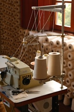 A sewing machine with spools of thread.