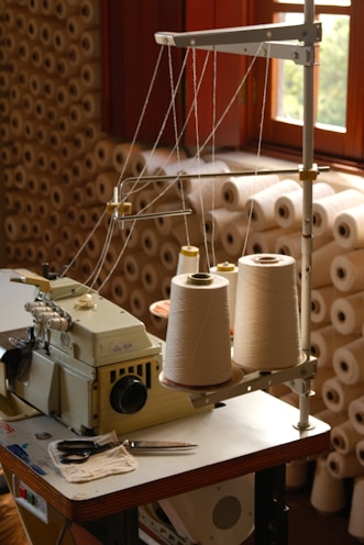 A sewing machine with spools of thread.
