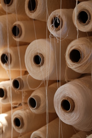 Spools of thread are stacked neatly together.