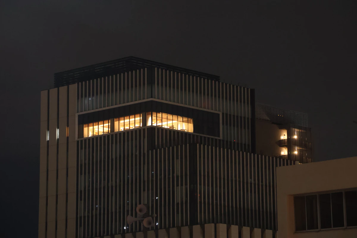 Illuminated building at night with several windows