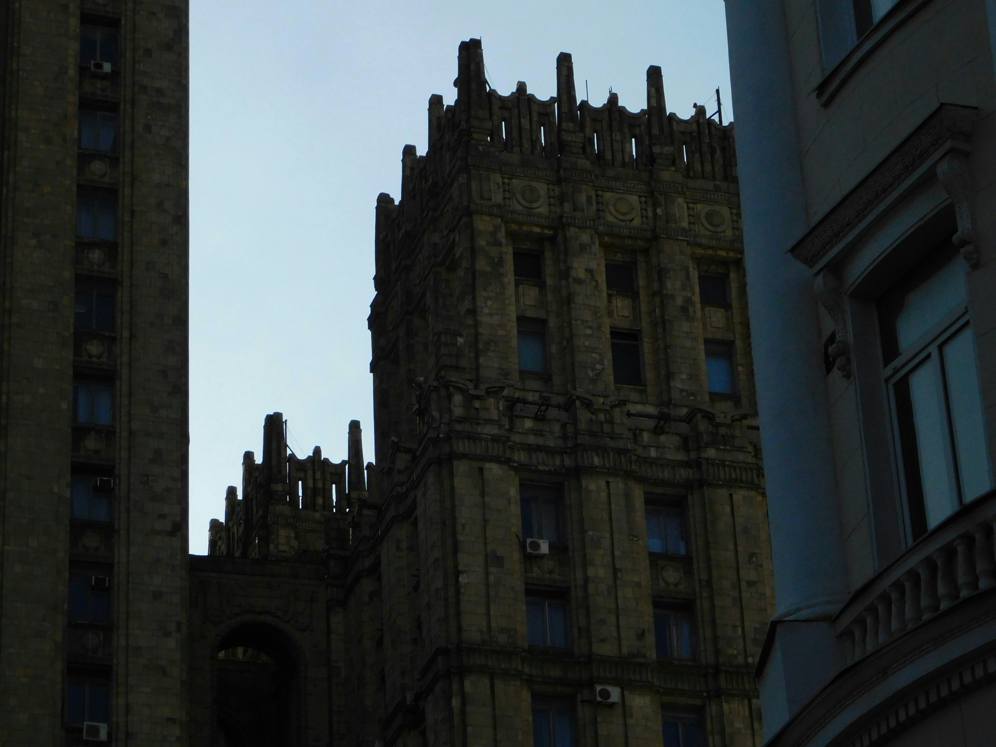 A tall, ornate building stands silhouetted.