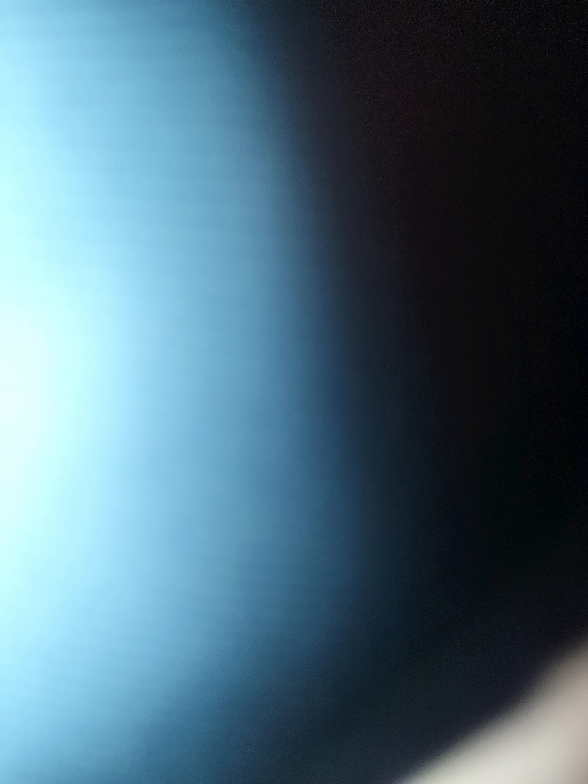 Bright light fades into dark space.