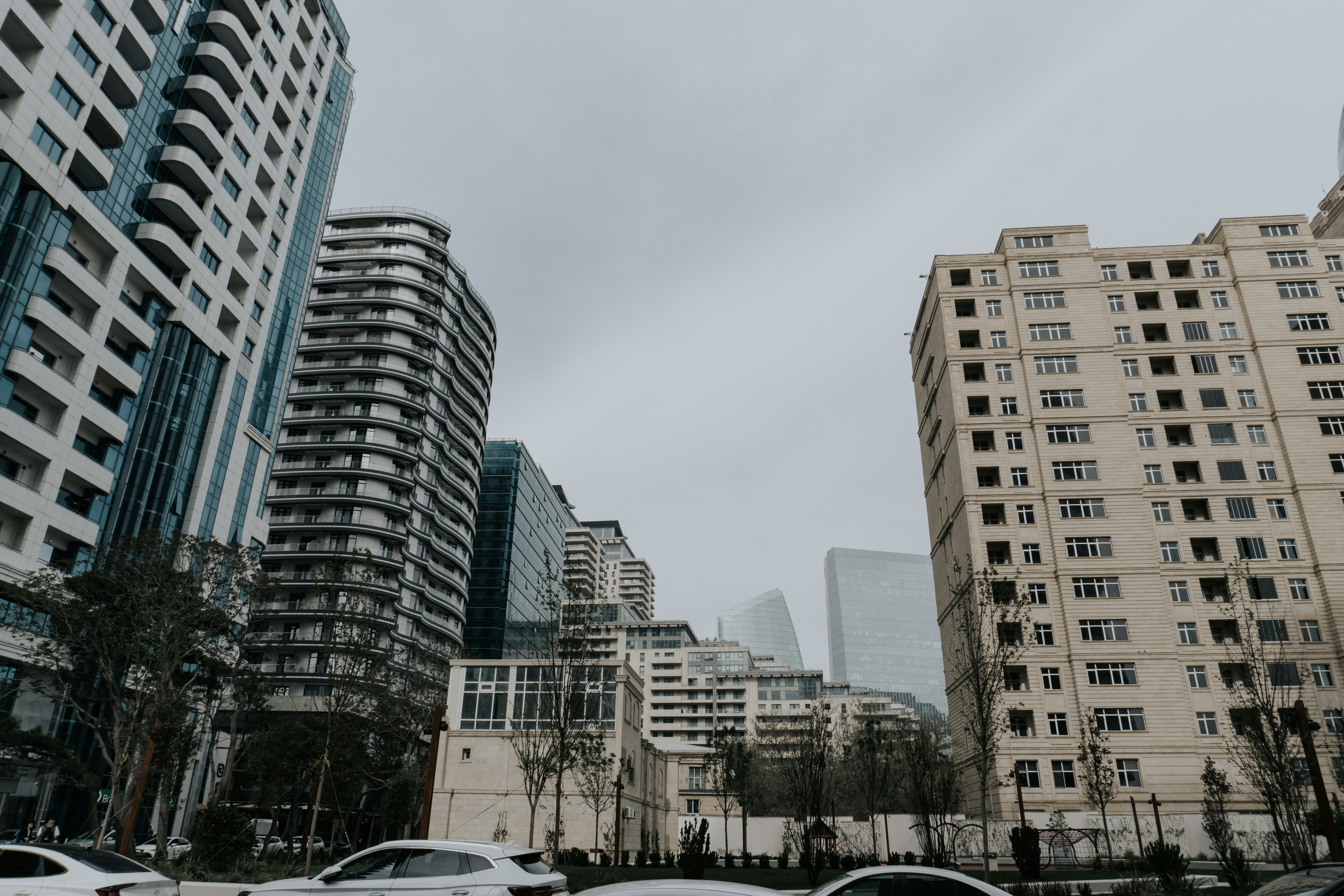 Buildings tower under a cloudy sky.