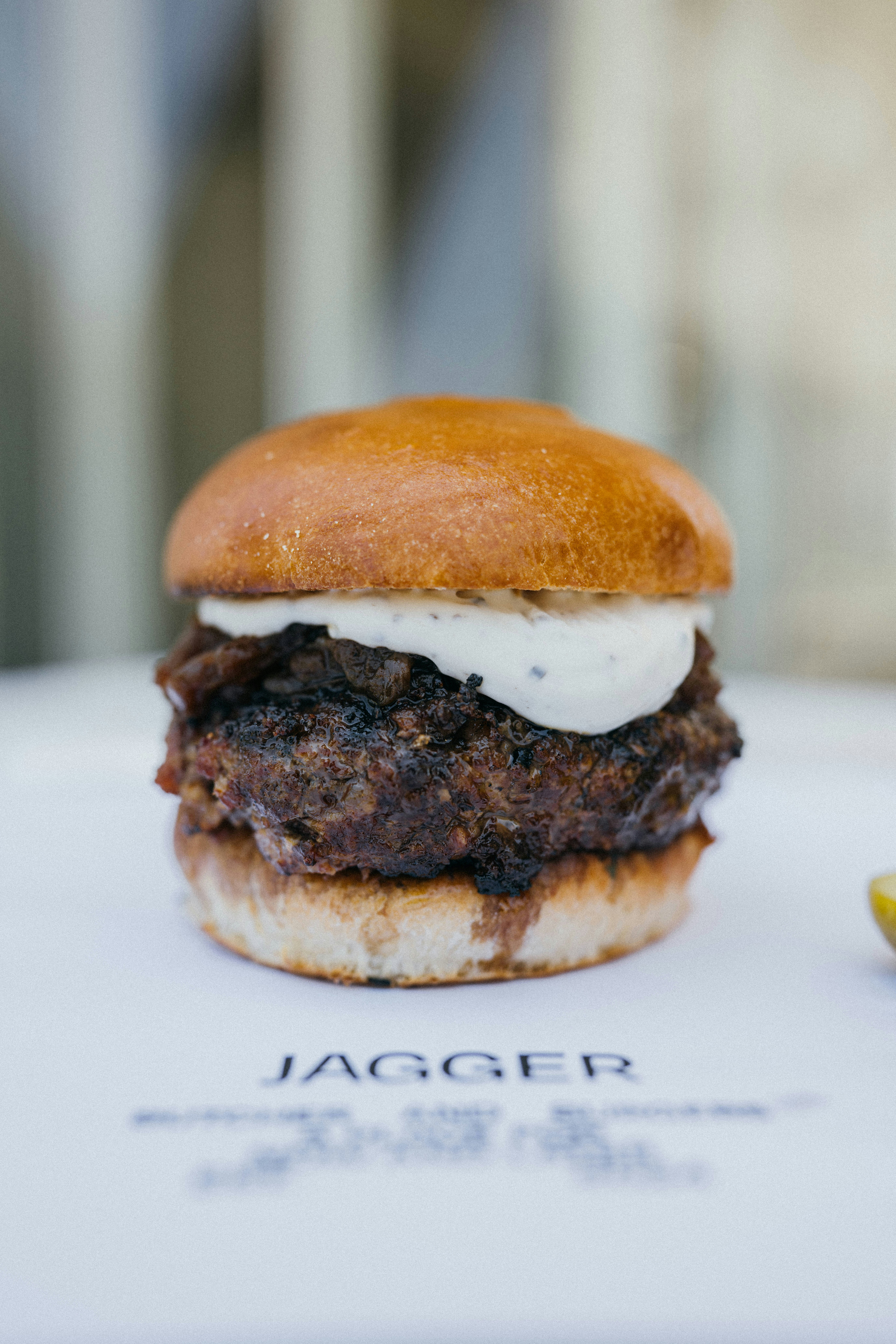 A delicious burger is served on a plate.