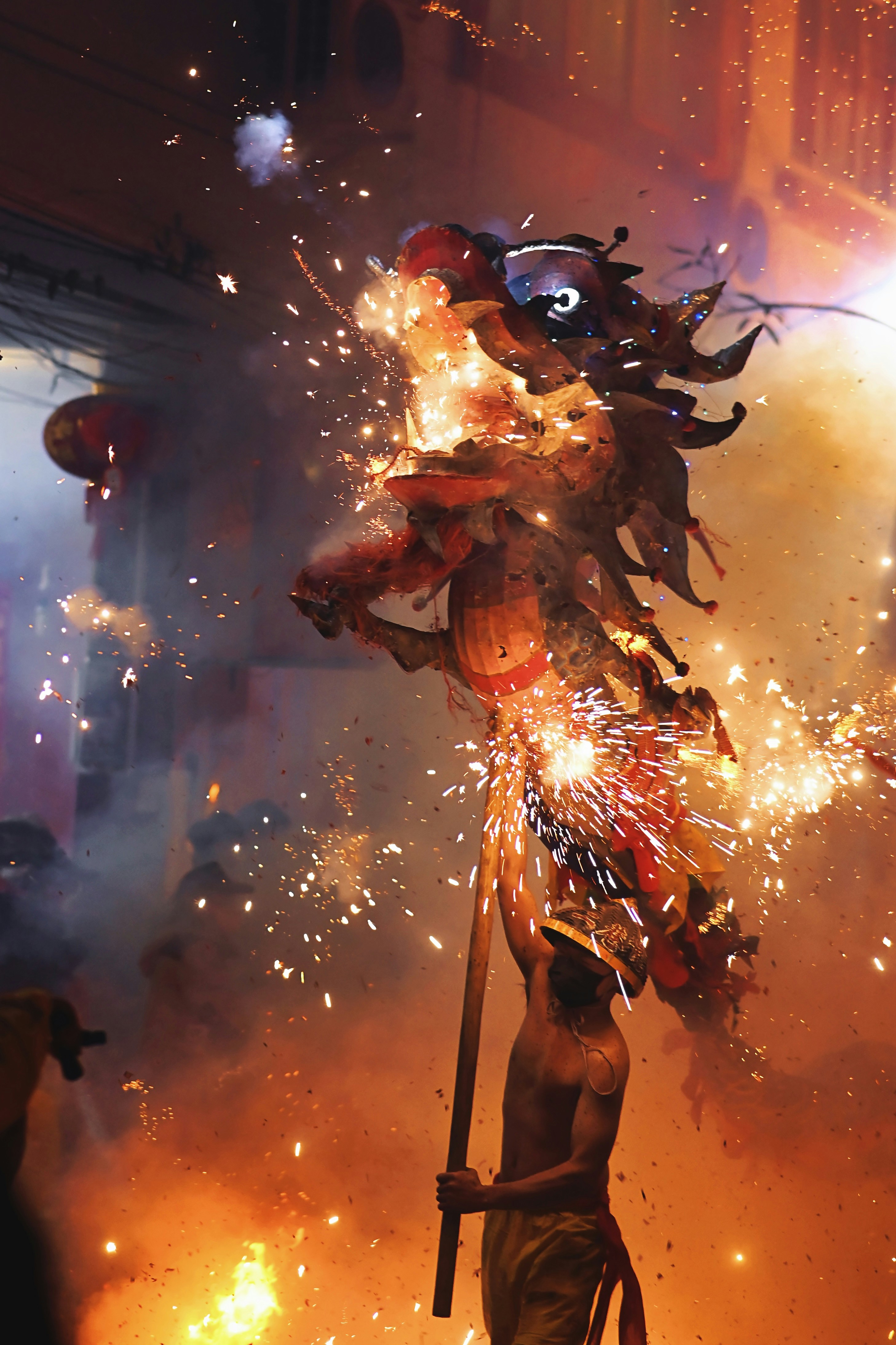 A dragon performs with firecrackers during a festival.