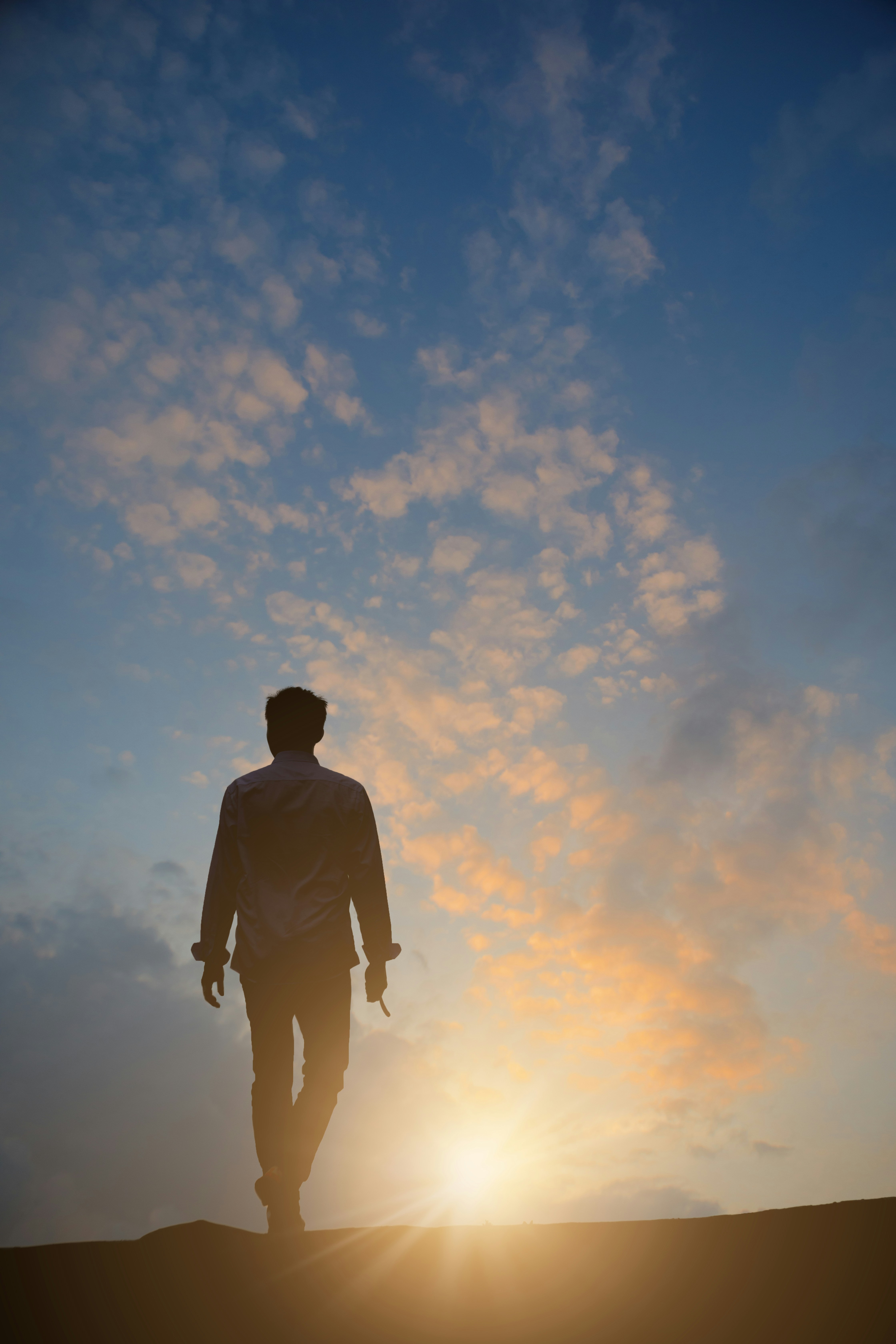 Man walks into the sunset.