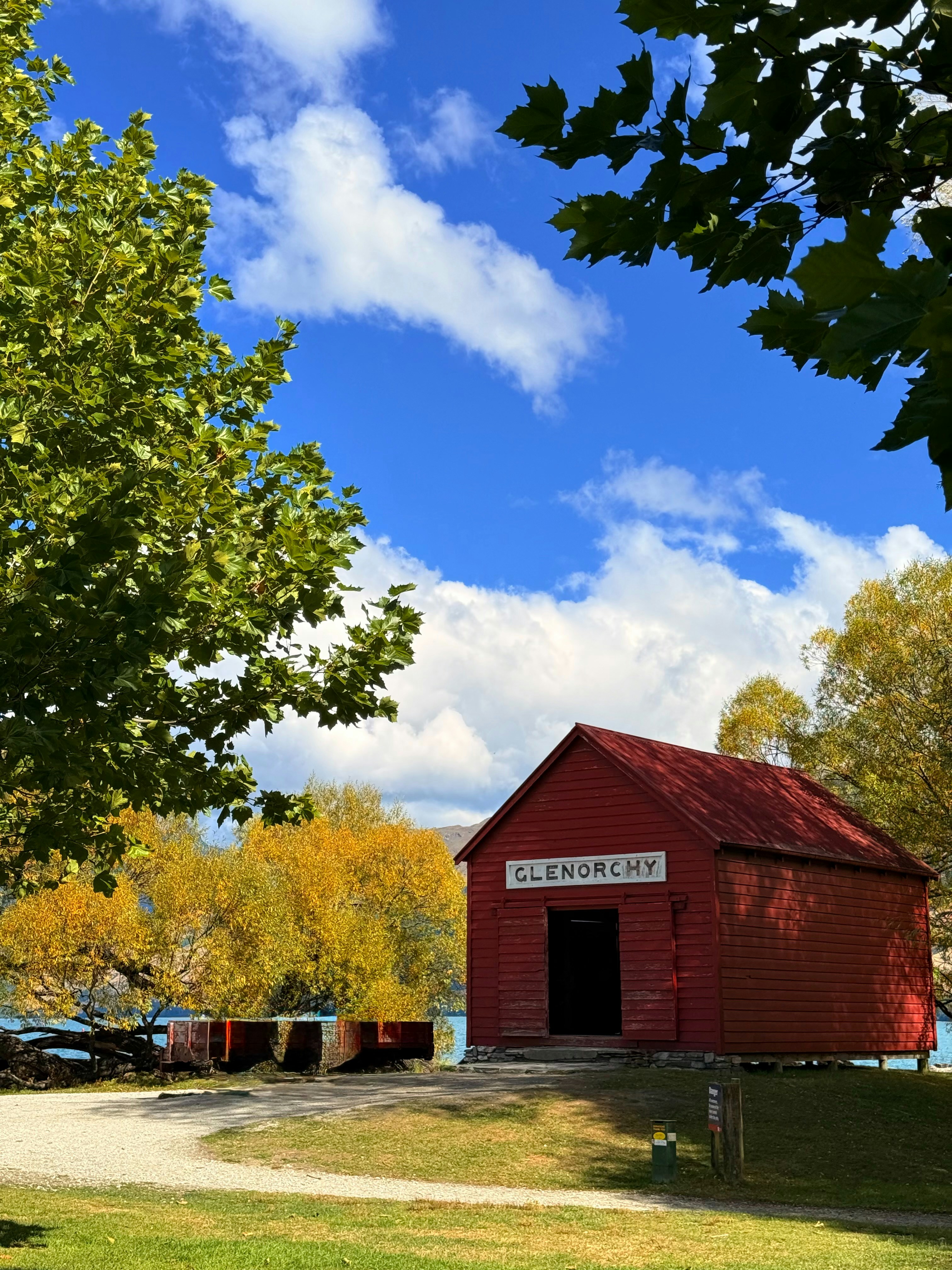 A red building under a bright blue sky.