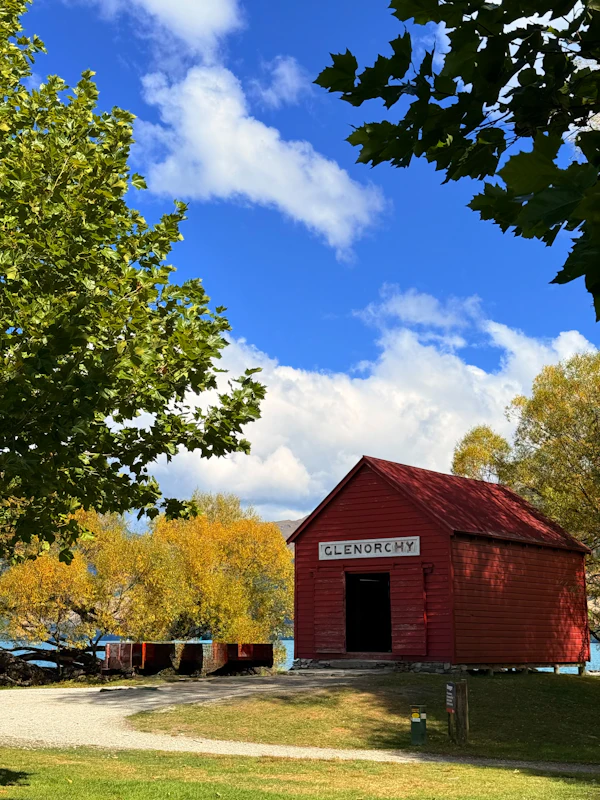 The red shed at Glenorchy wharf under a blue sky