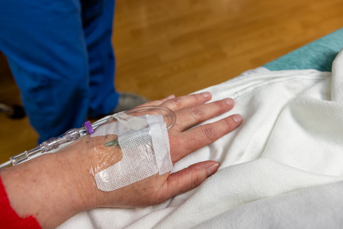 Patient receiving an infusion in a hospital infusion suite