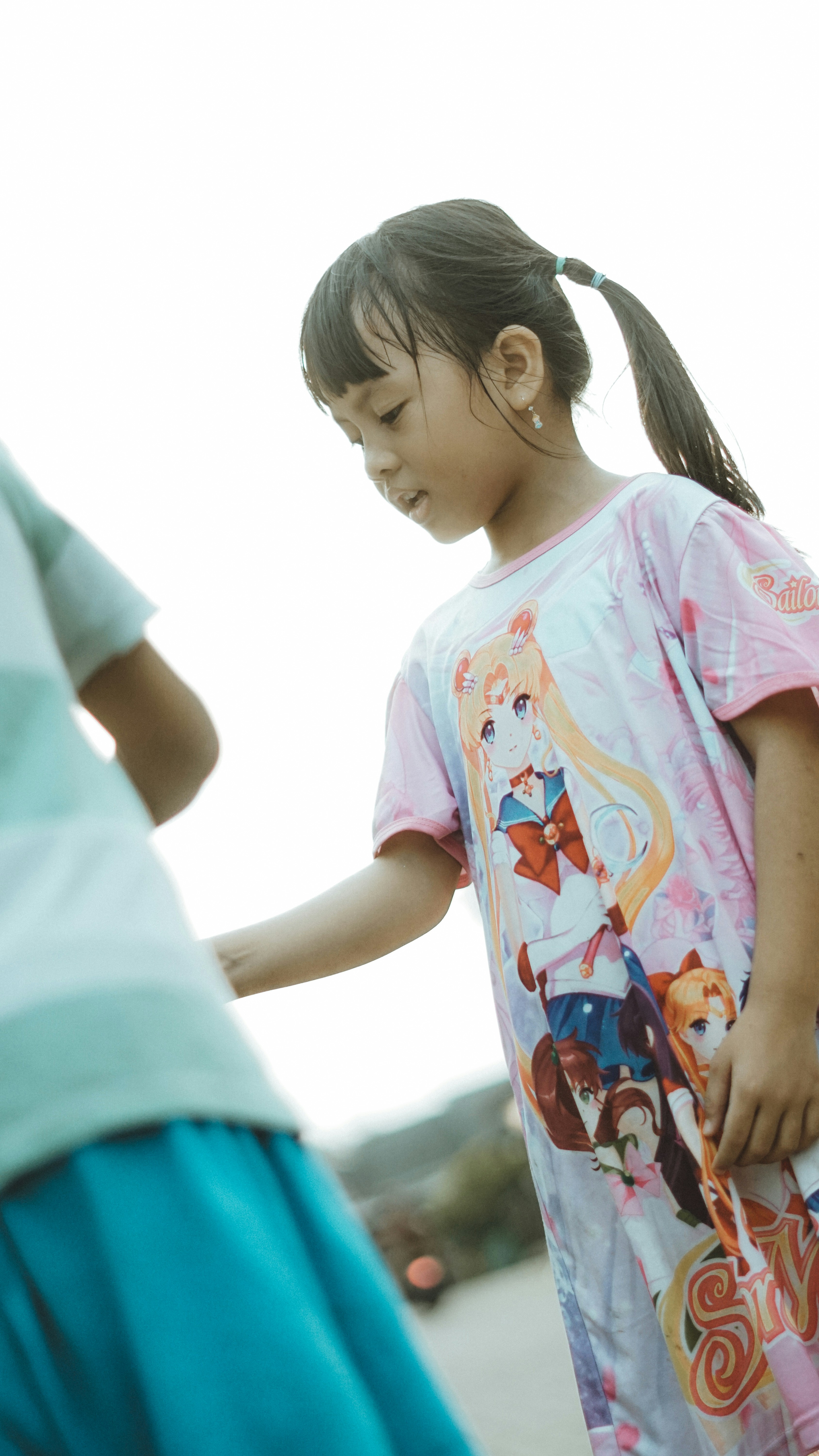 A girl is looking down at something.