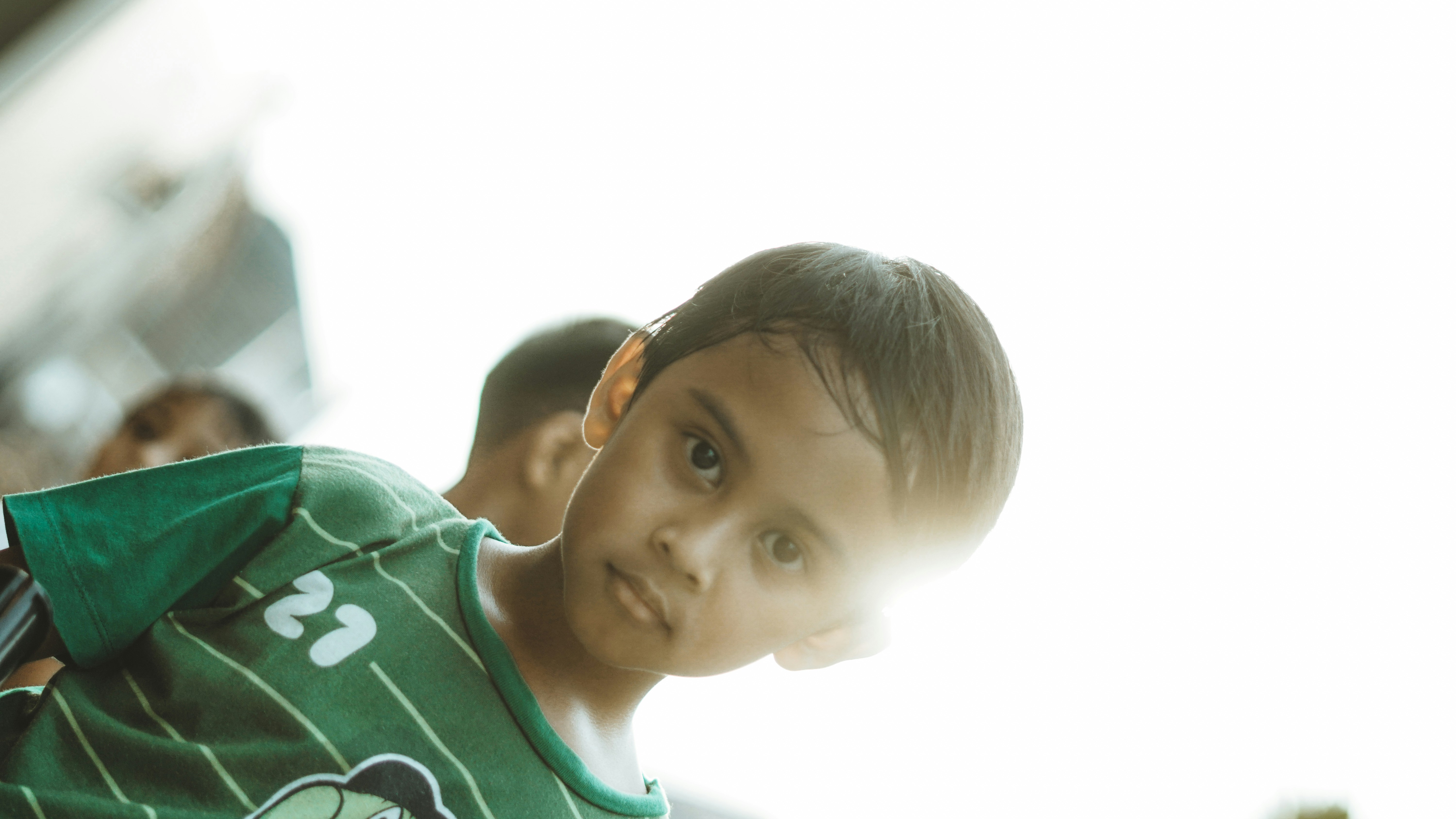 A young boy looks directly at the camera.