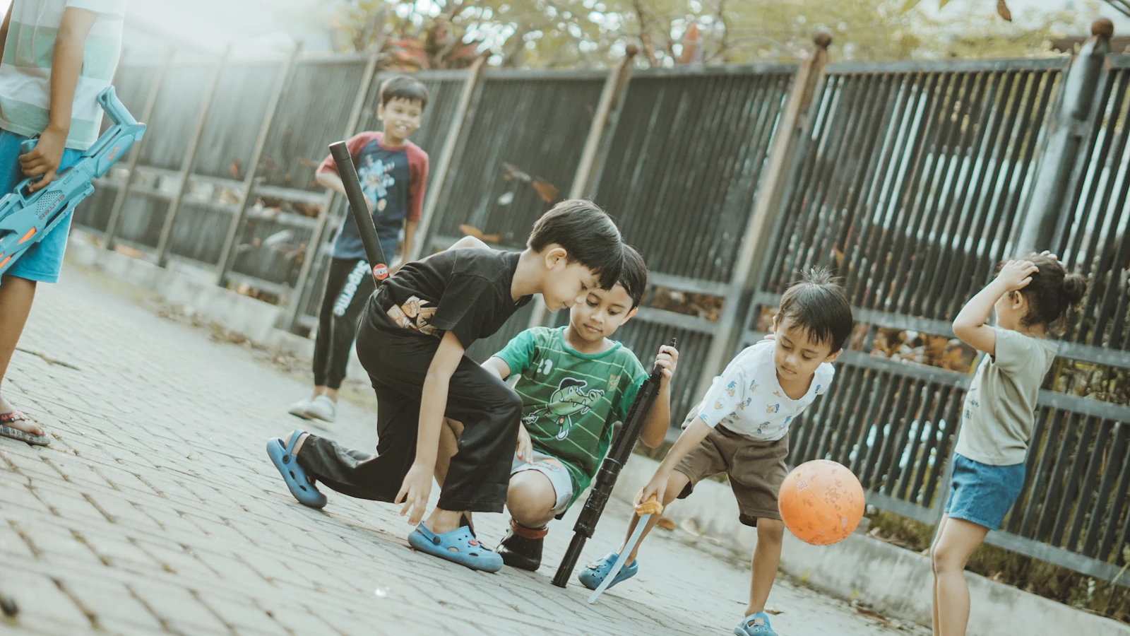 Children playing together with a ball on the field