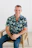 Smiling man sits in a chair