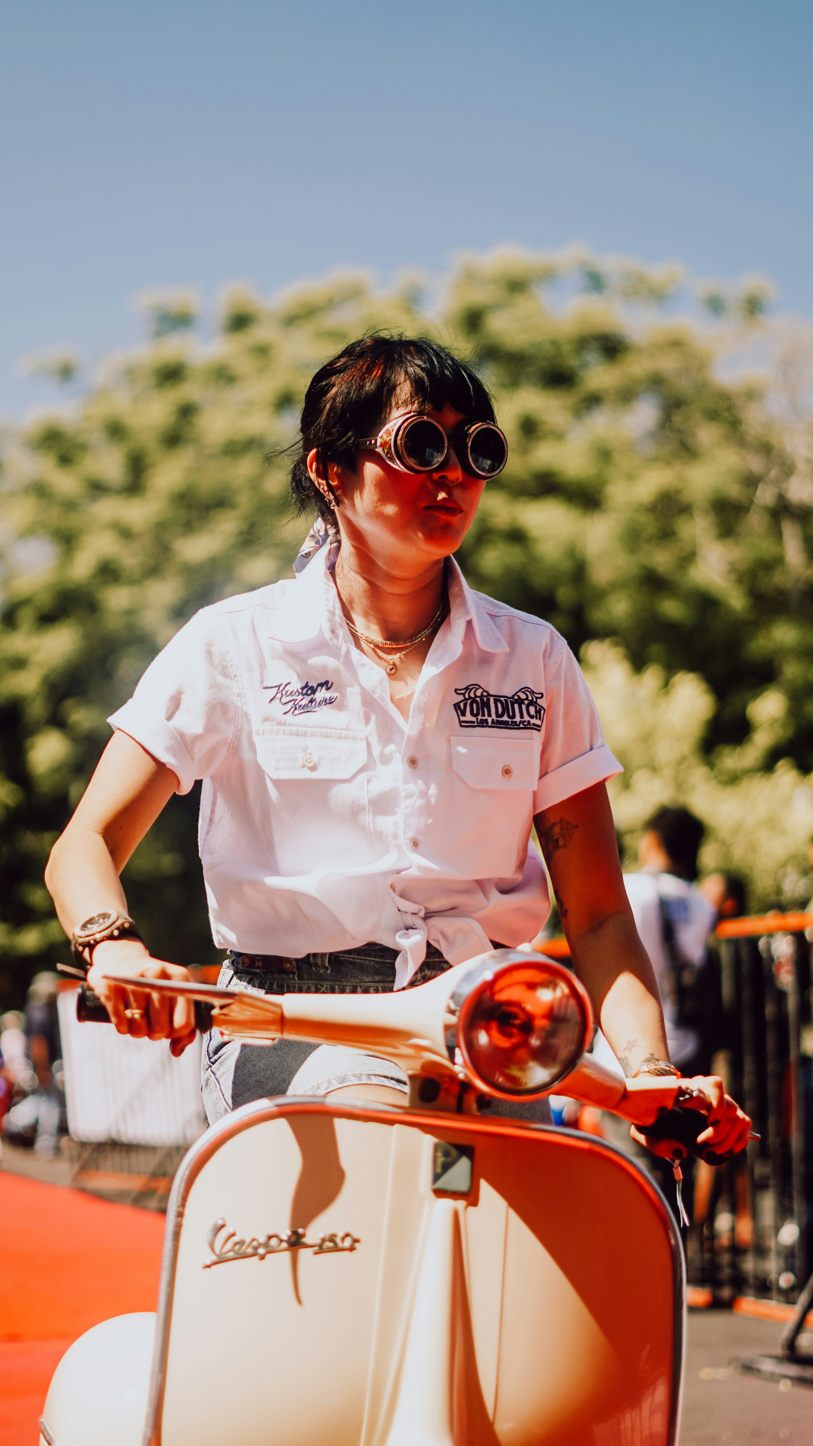 A group of diverse motorcyclists standing together with their bikes