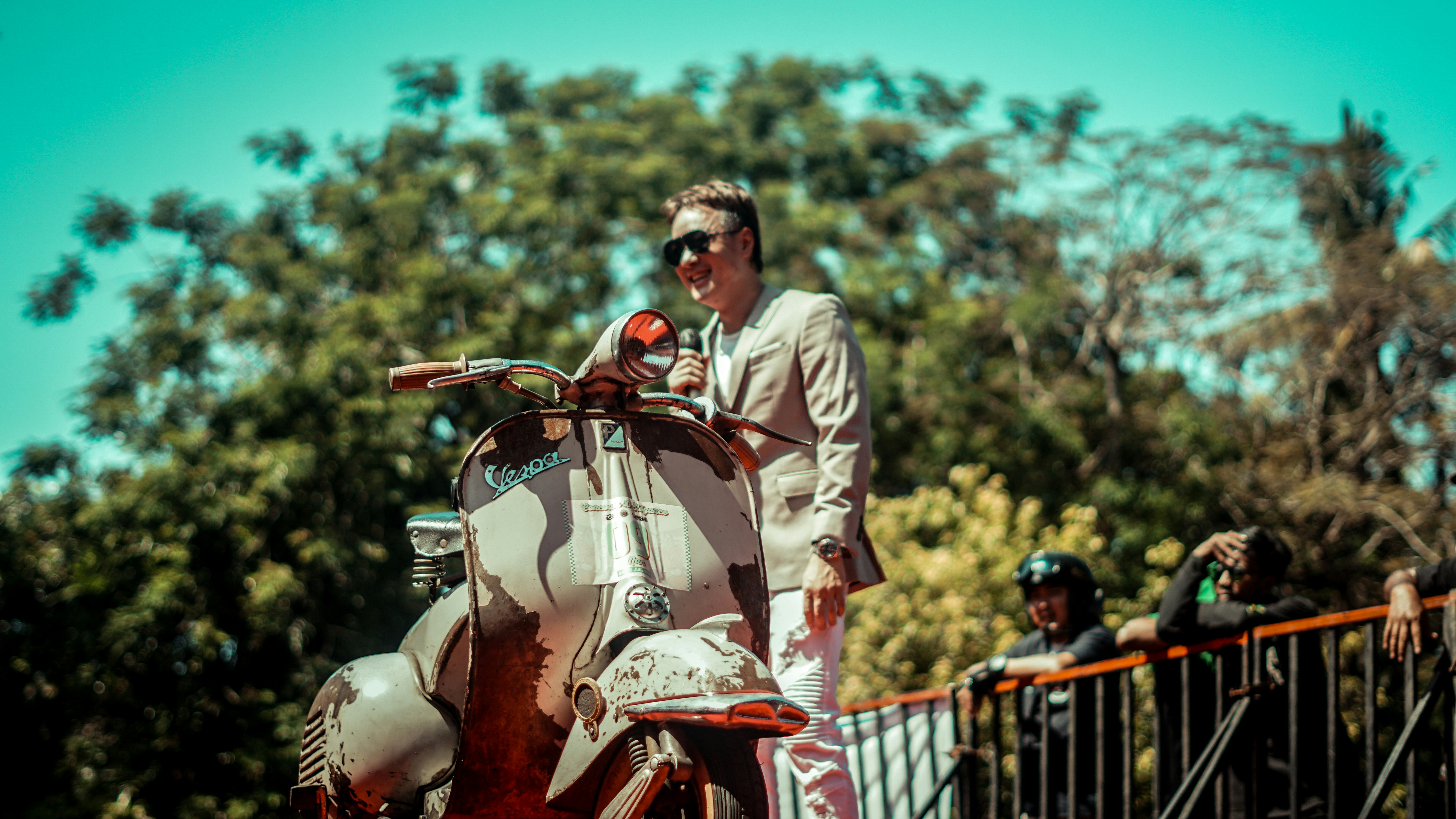 A man poses with his vintage scooter.