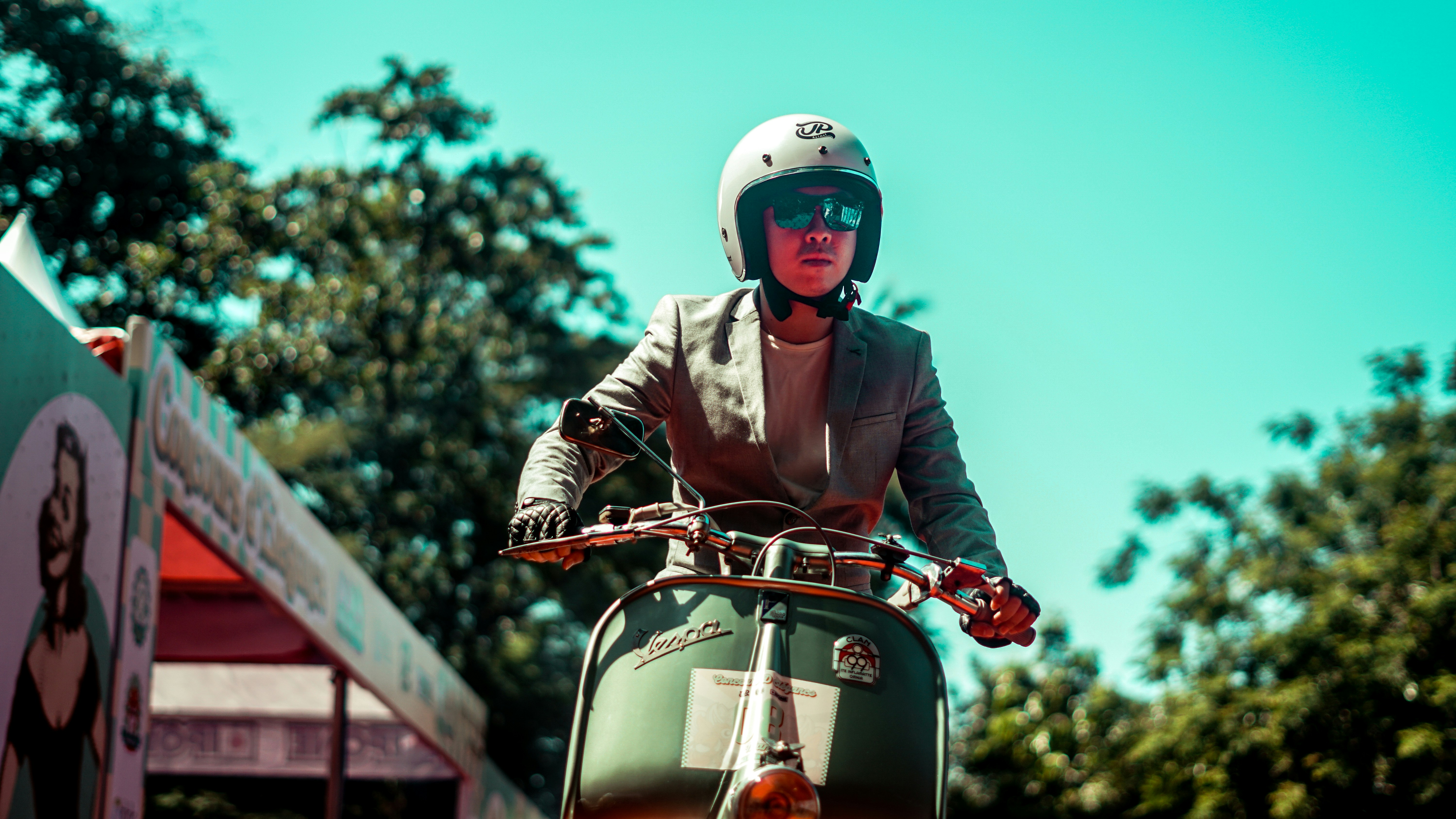 A person rides a scooter down the street.