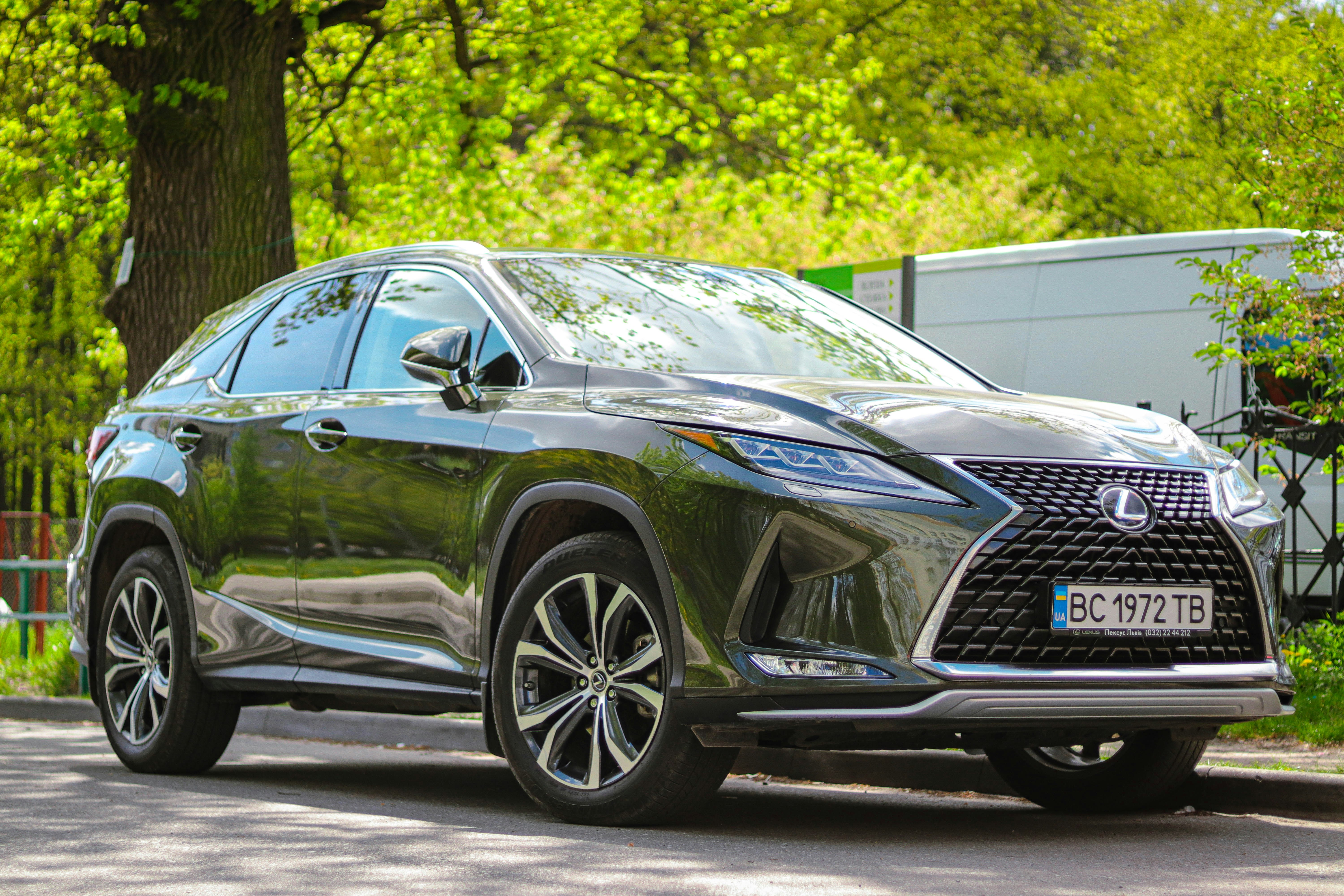 A dark gray lexus suv is parked outside.