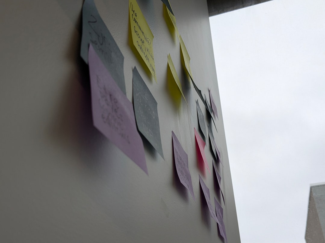 Creative brainstorming session with sticky notes covering a wall, showing the quote development process - funny original yearbook quotes