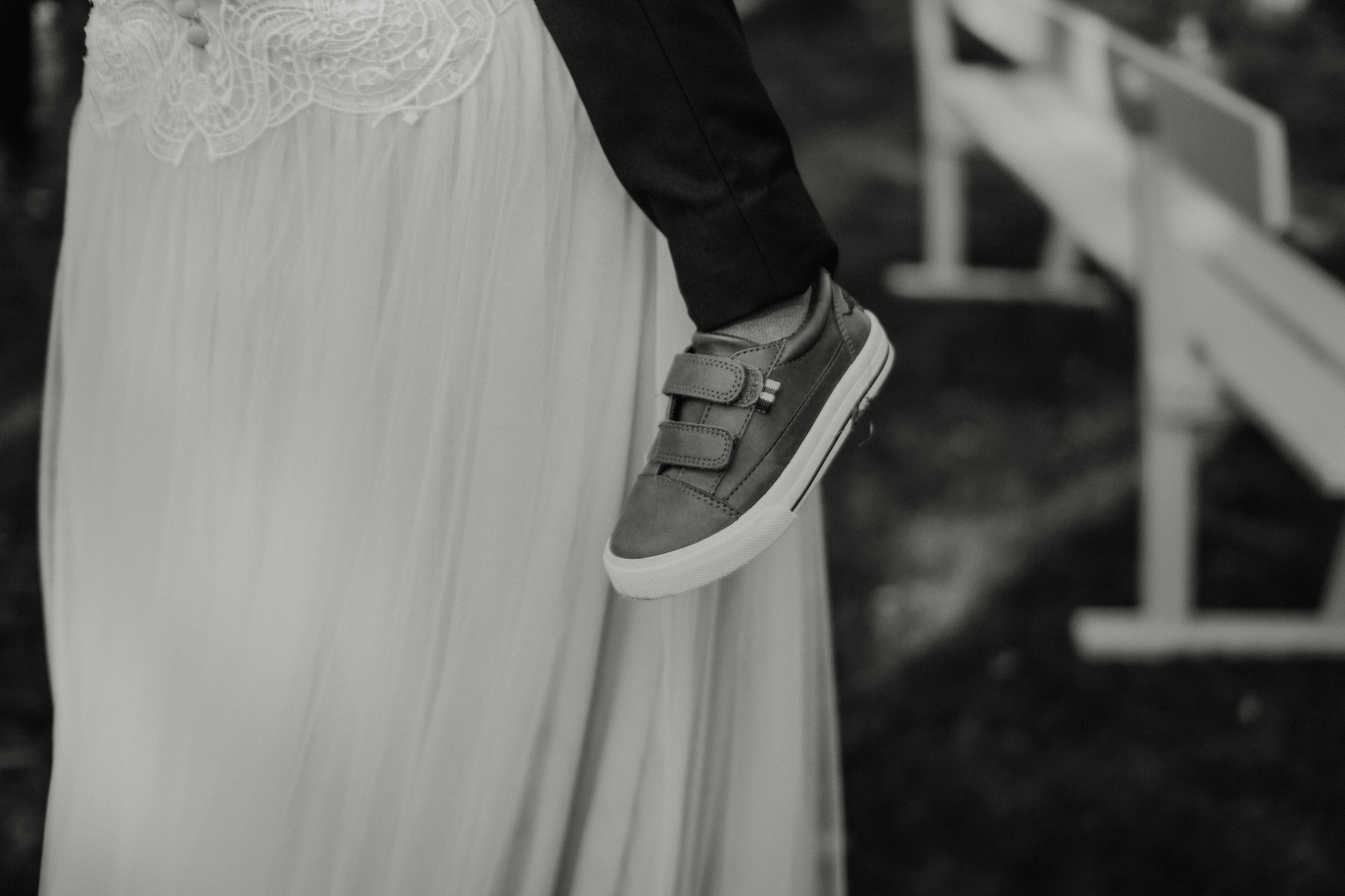 A child's shoe is visible on a wedding day.
