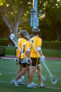 Lacrosse players walk across the field together