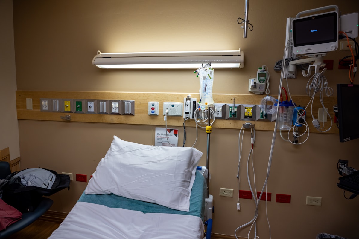 Nurse using an AI shift handoff tool on a tablet at the bedside