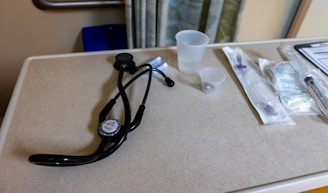 Medical tools lie on a hospital table.