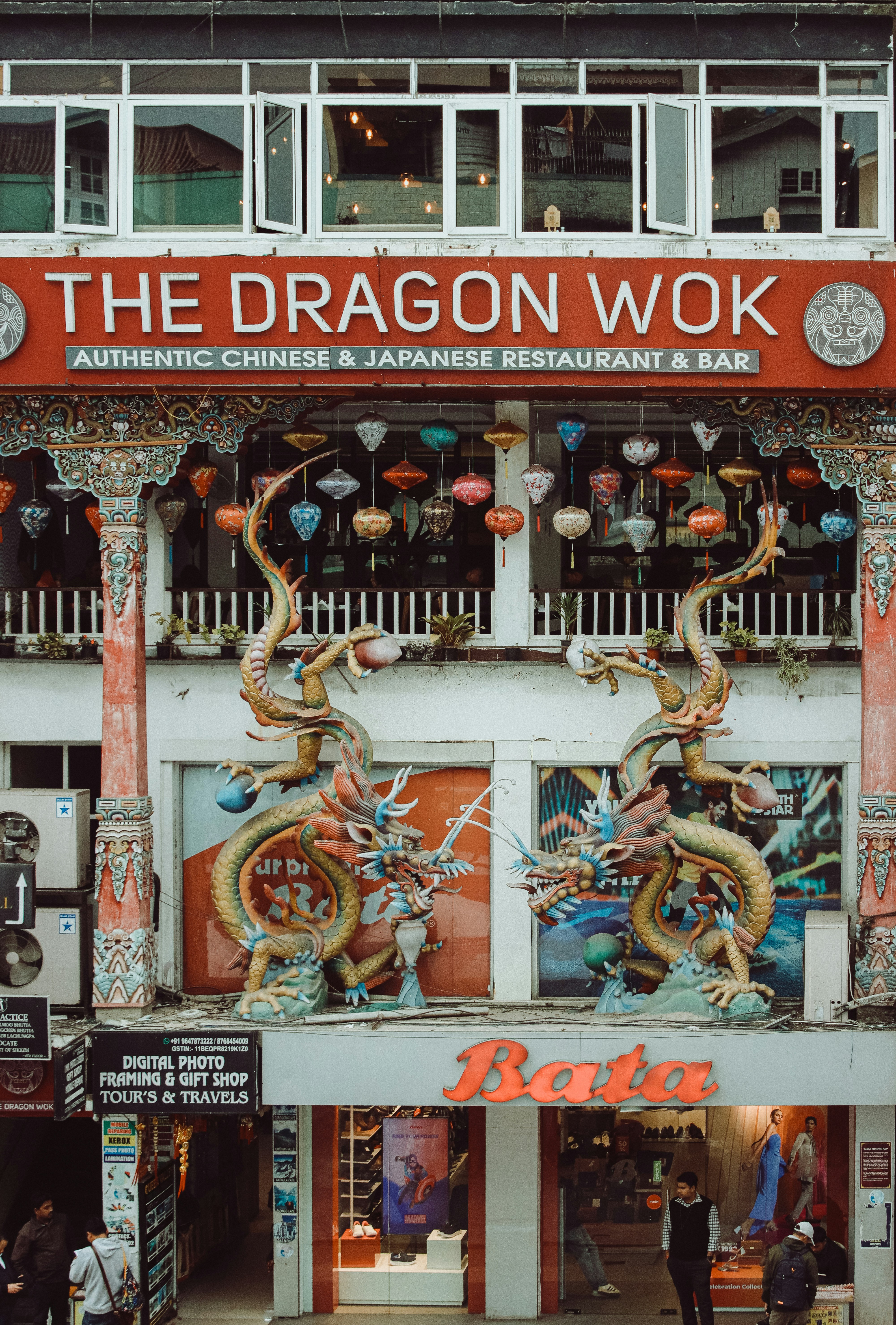 A restaurant, "the dragon wok", adorned with dragons.