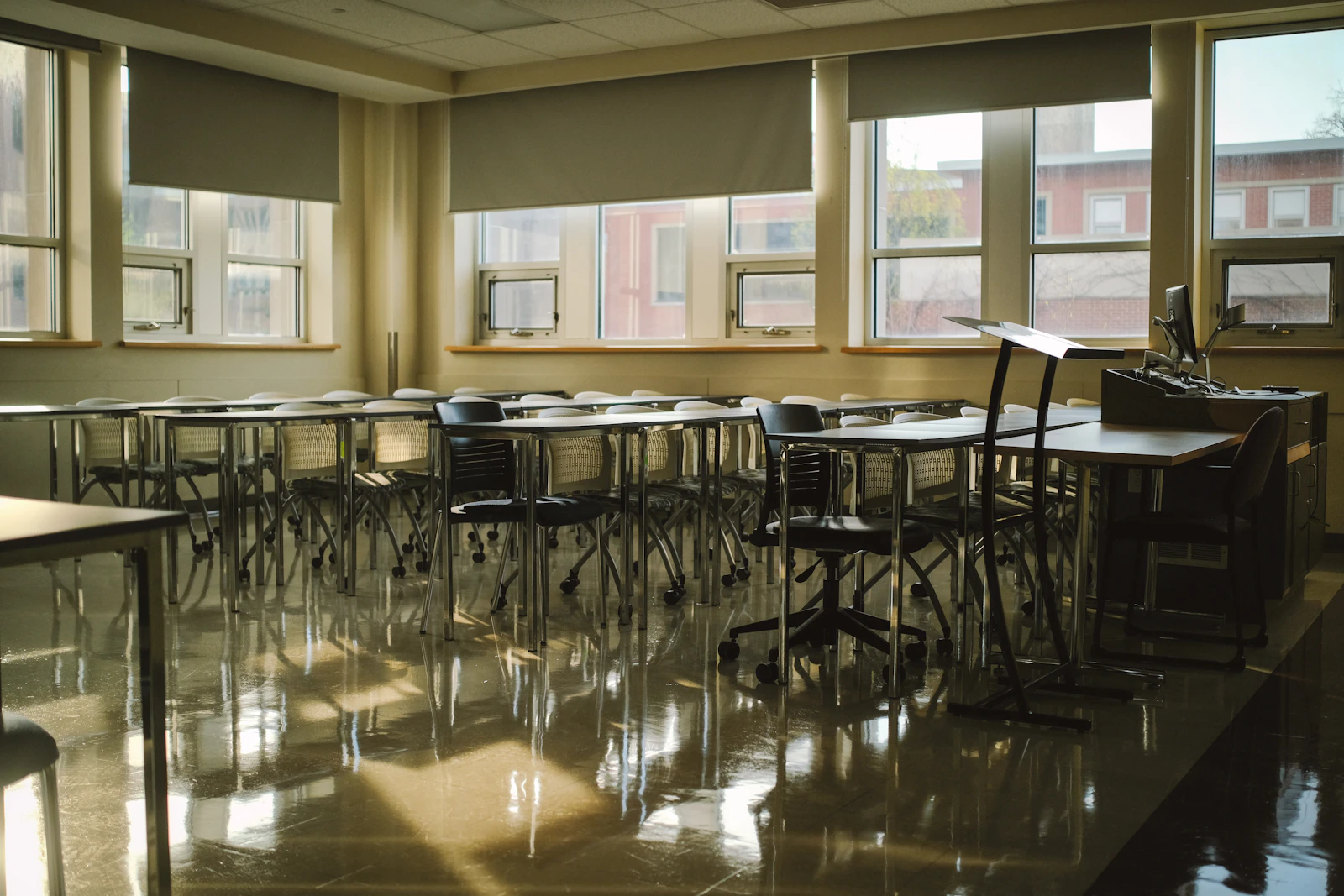 An empty classroom with sunlight reflecting through windows