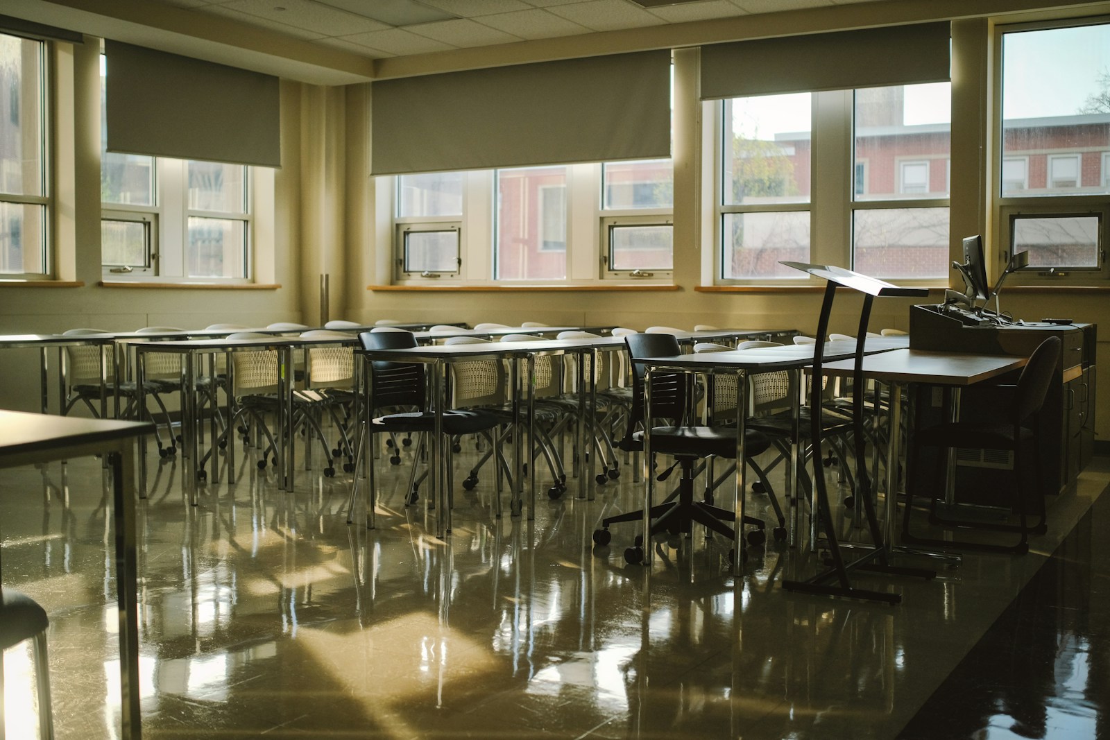 Classroom desks and chairs on polished resilient sheet flooring