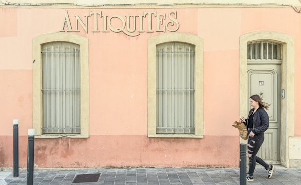 An antiques shop on a pink-washed street — Perpignan, France