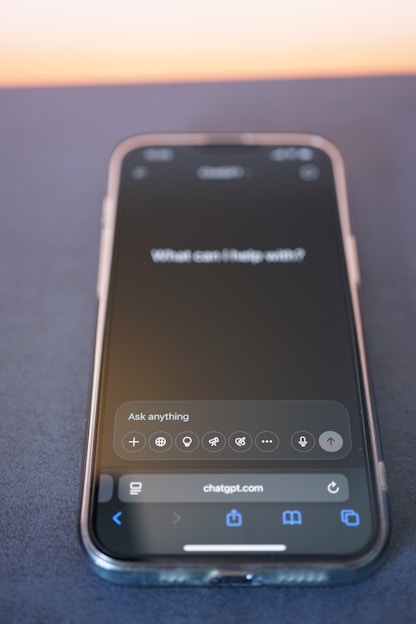 A phone displays chatgpt on its screen.
