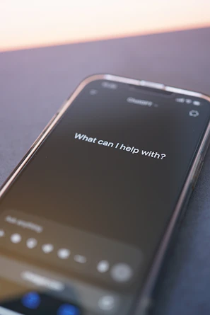 Phone screen asks: "what can i help with?"