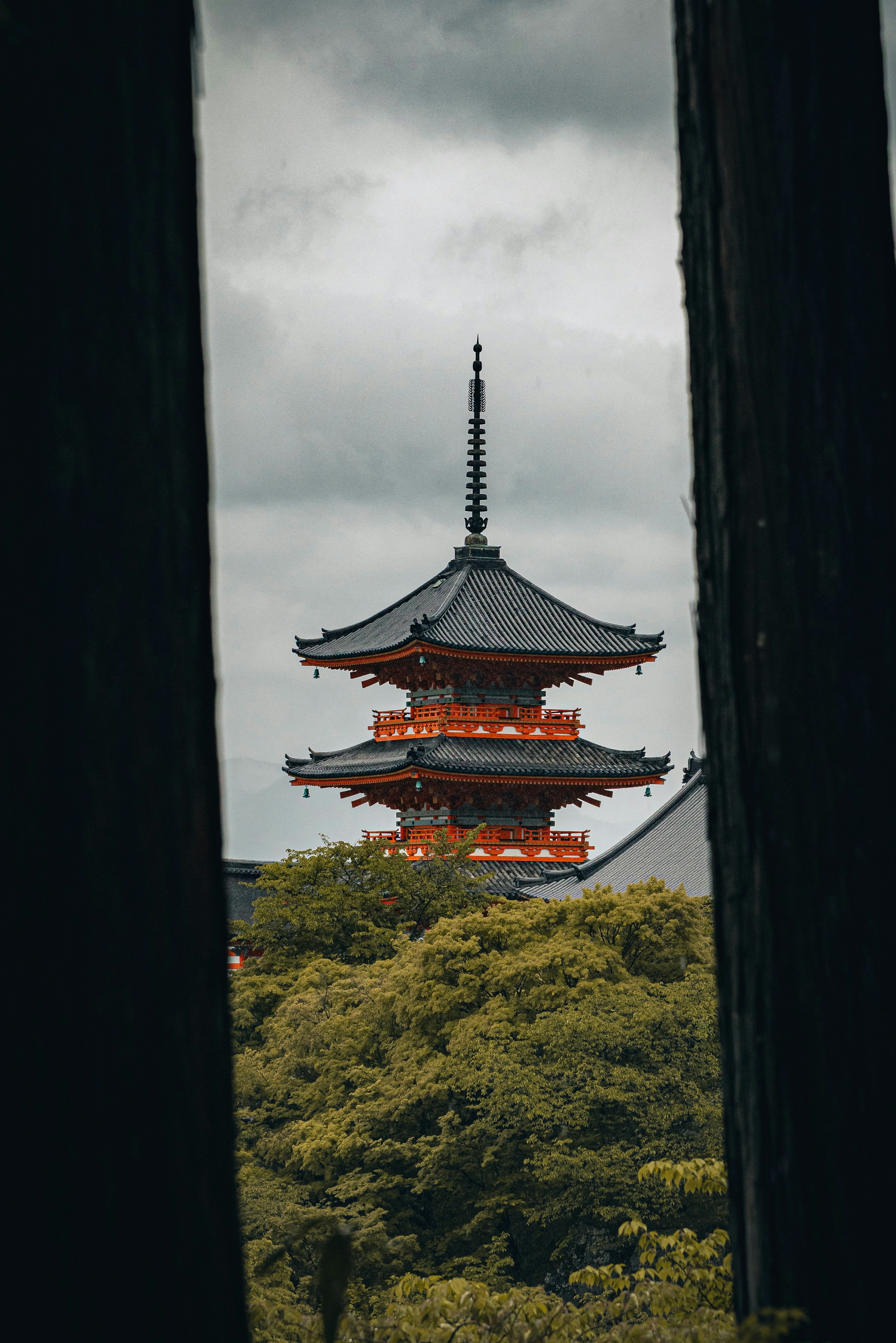 A japanese pagoda framed by trees.
