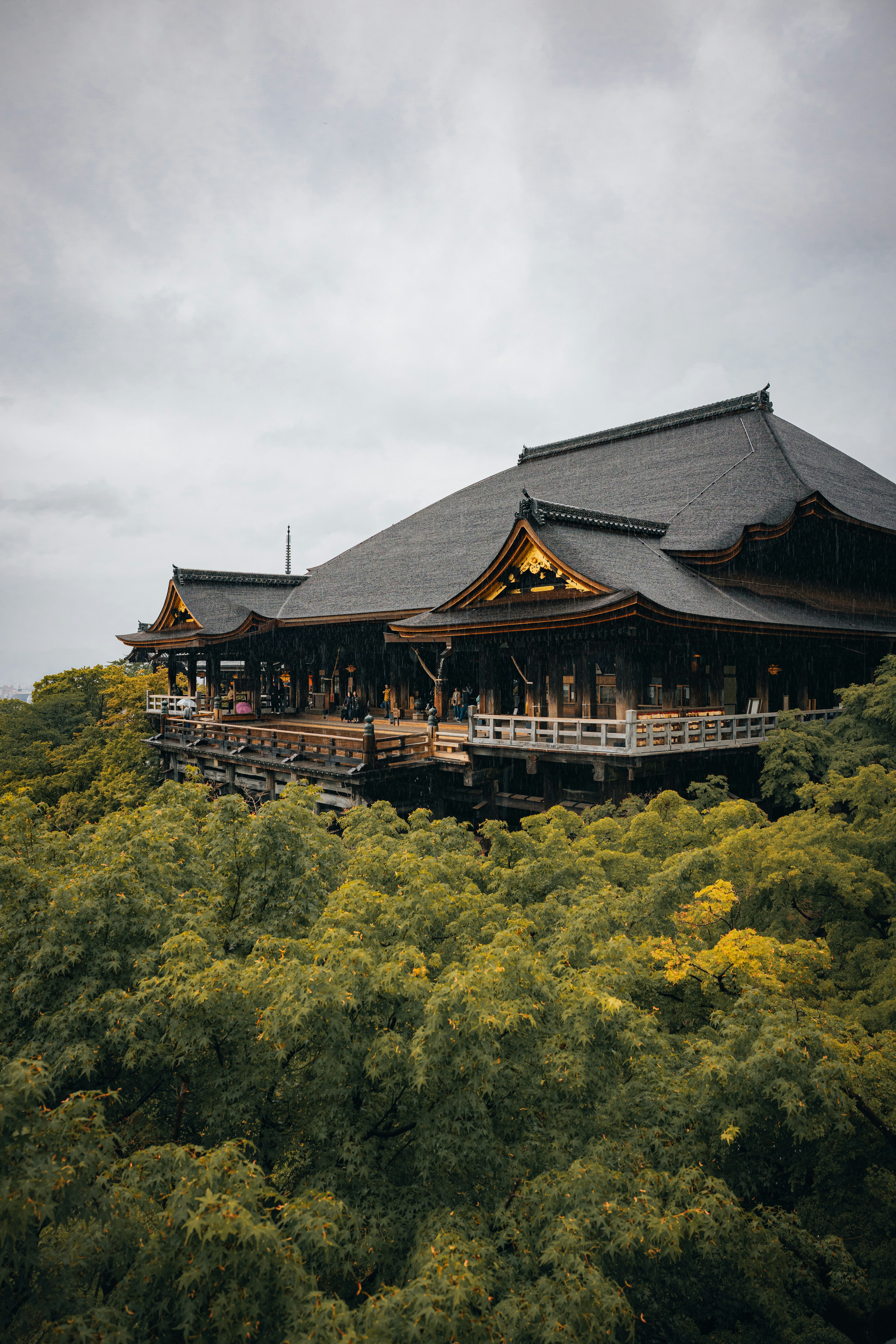 A temple rests among lush green trees.