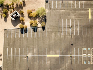 Empty parking lot with some trees nearby.