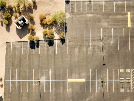 Empty parking lot with some trees nearby.