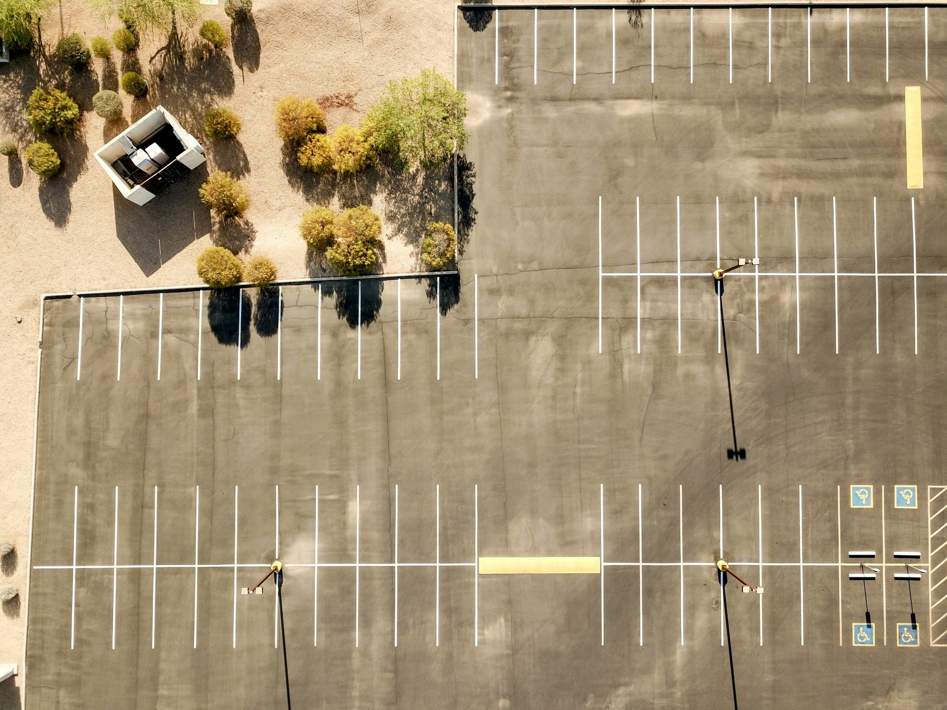Empty parking lot with some trees nearby.