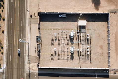 Overhead view of rooftop machinery and a road.