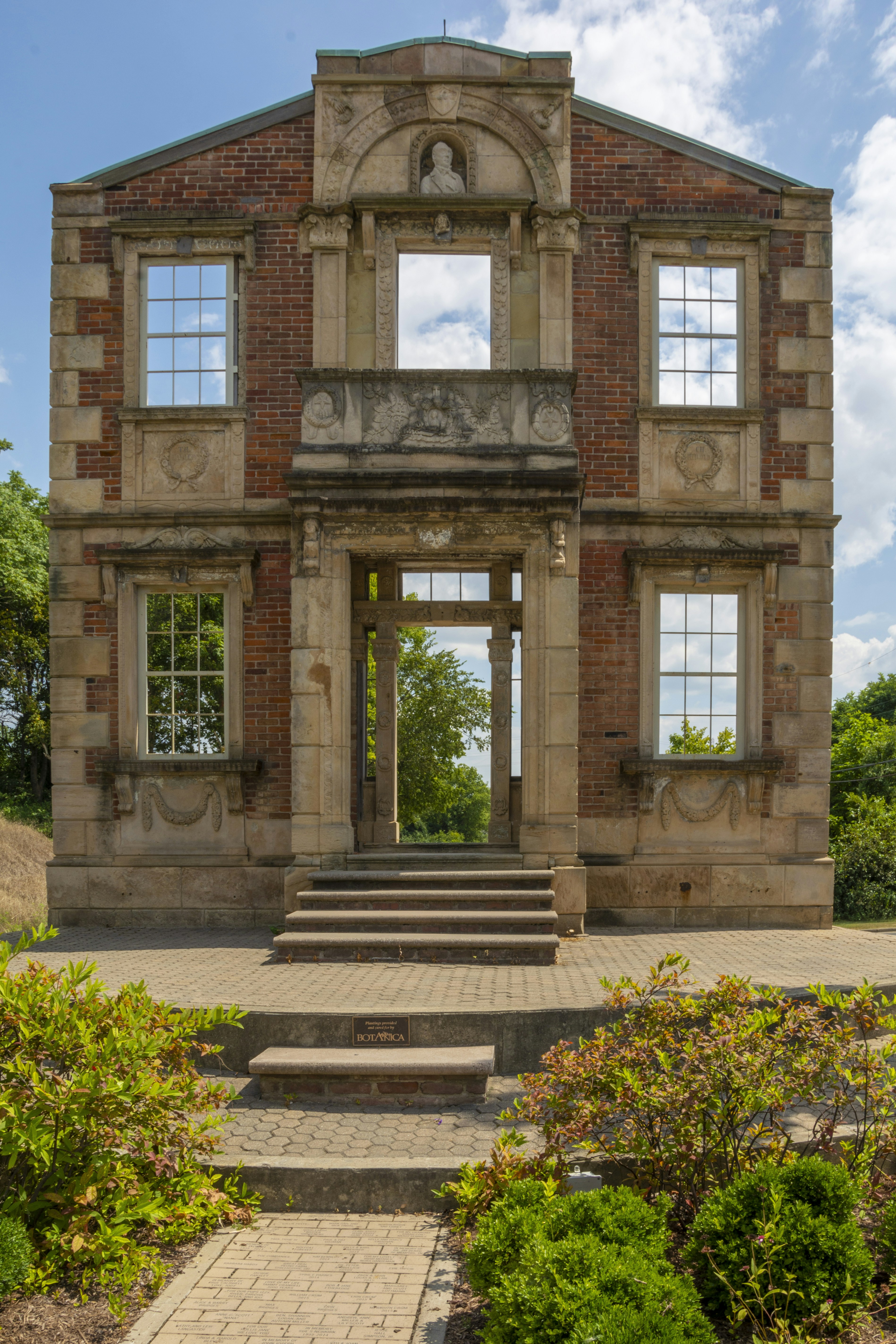 Ruined building facade with open doorways and windows.