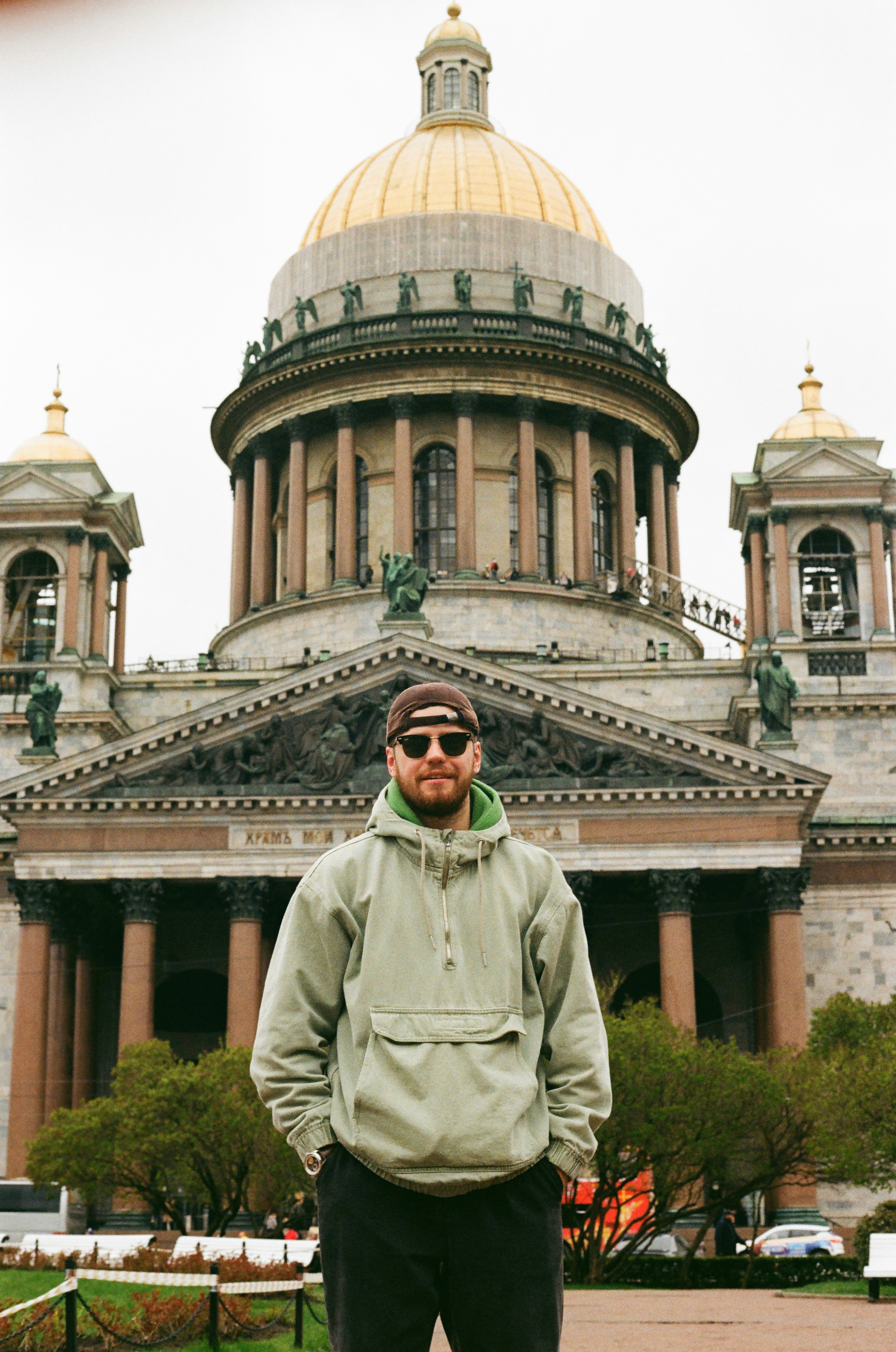 Man stands in front of a cathedral.