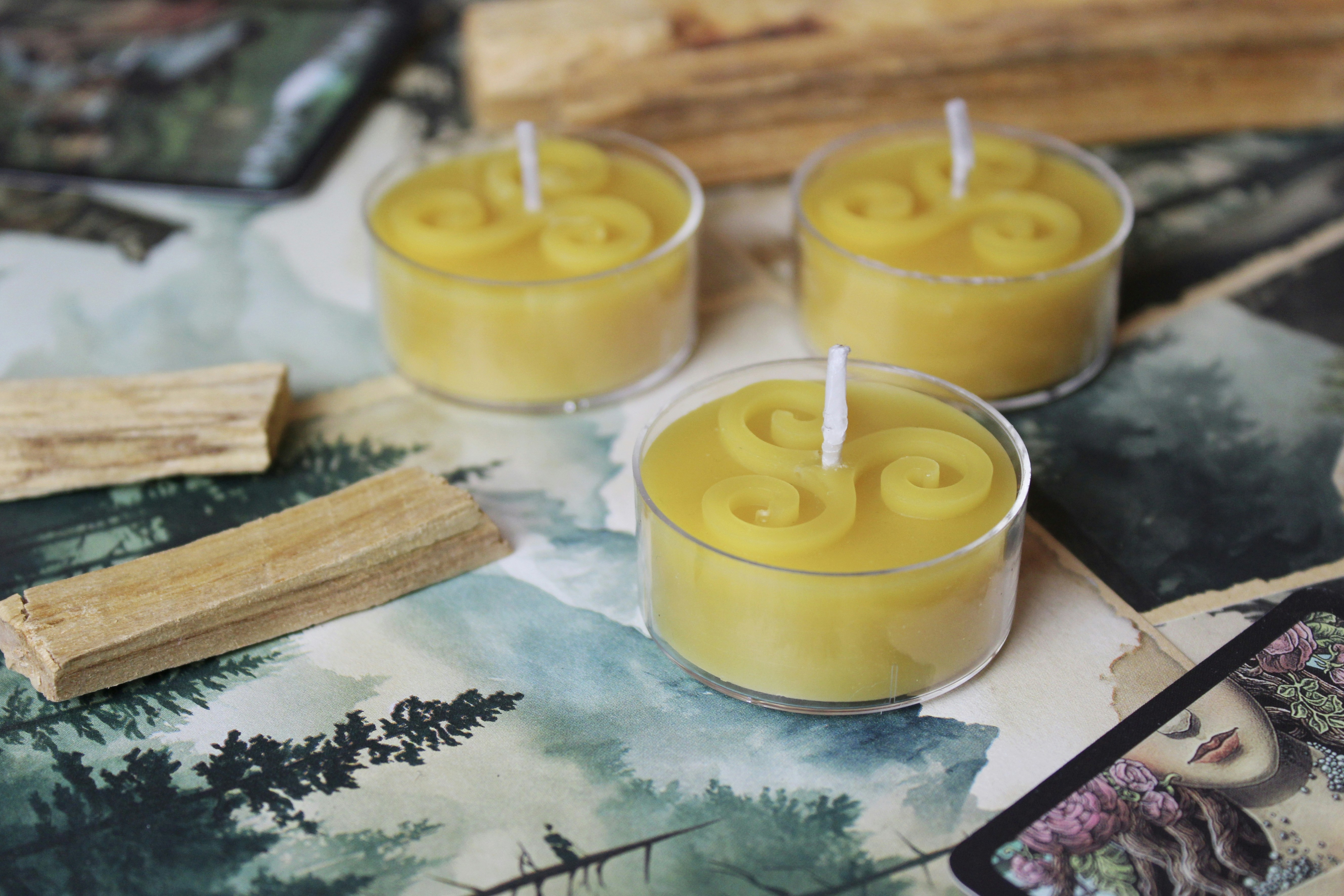 Three candles and some wood laid out.